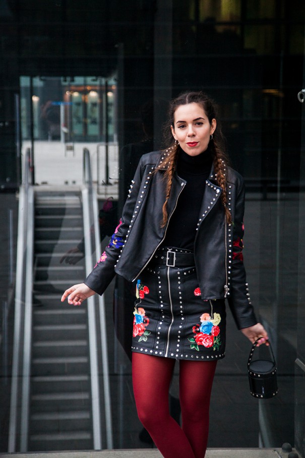 outfit con giacca e gonna di pelle nere con fiori ricamati